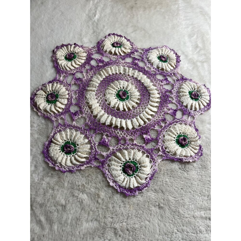 Crocheted purple flower rounded granny Doily